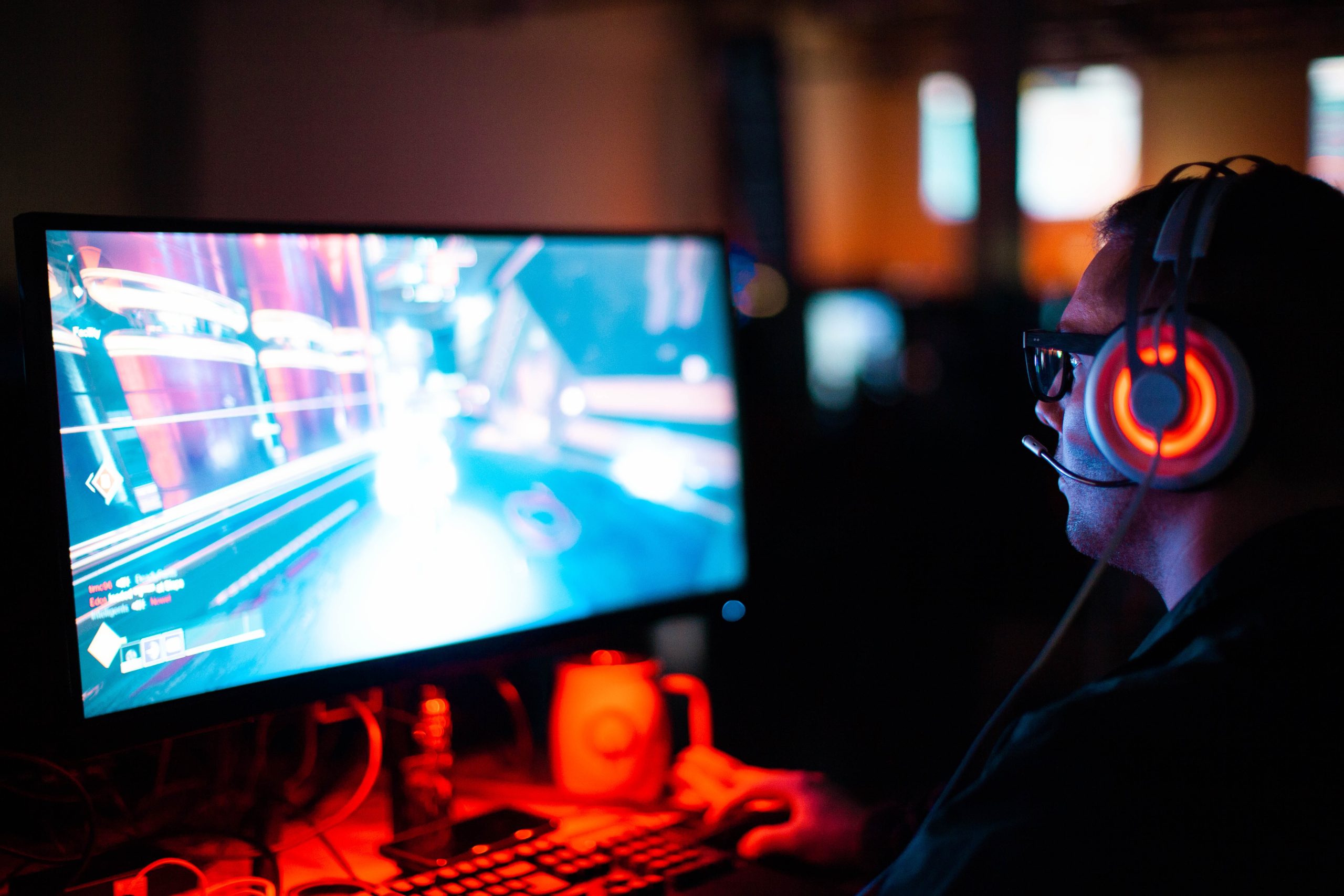 Ein Mann mit Headset spielt ein Videospiel an einem Computer
